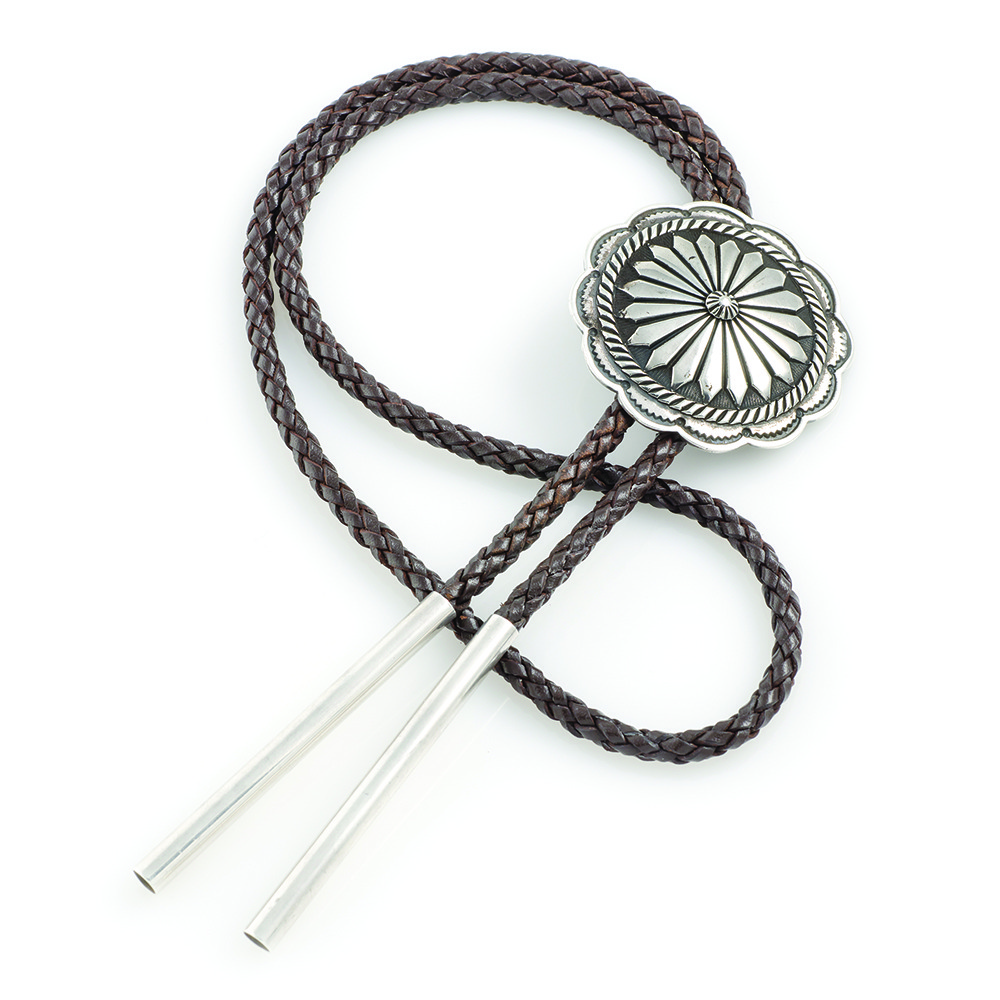 Brown braided leather bolo tie with a silver concho featuring a sunflower design